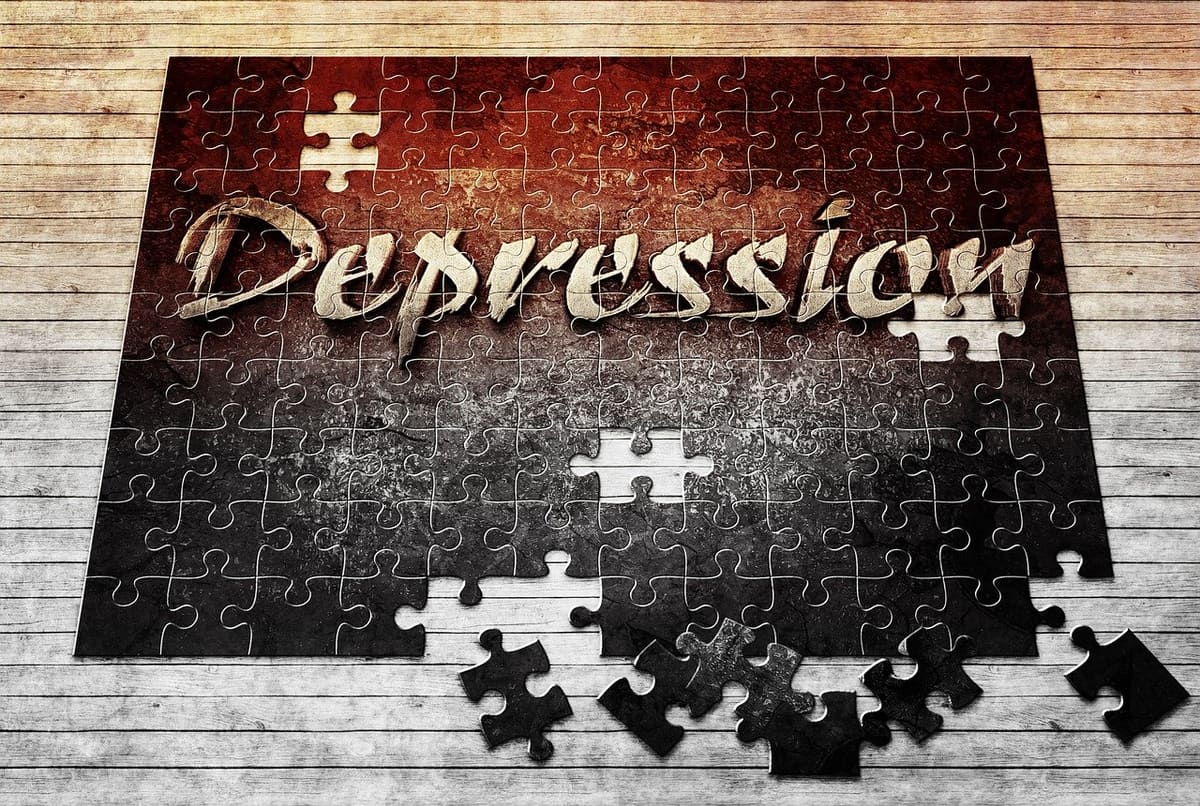 Overcoming depression with hypnotherapy The word "depression" on an unfinished jigsaw puzzle
