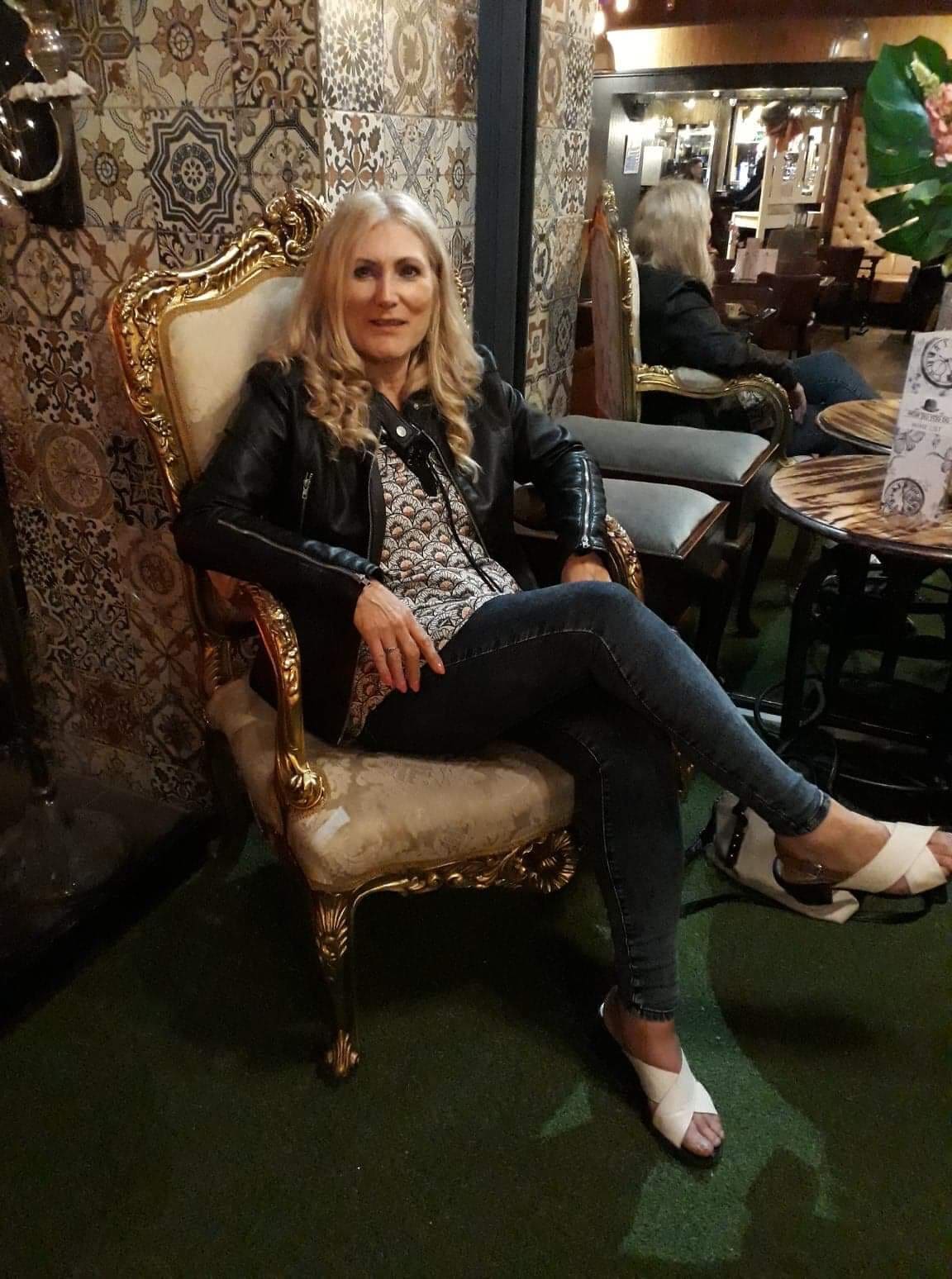 Sonya Hudson Sonya Hudson seated in an ornate armchair
