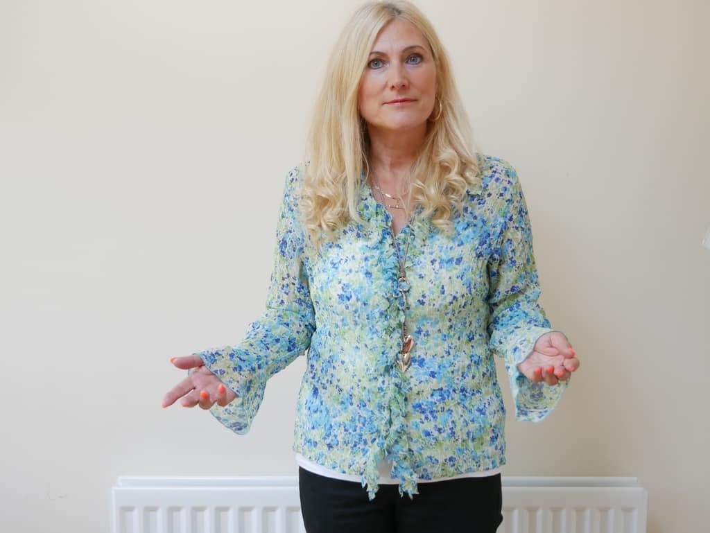Clinical hypnotherapist Sonya Hudson Sonya Hudson standing with open arms in a bright room